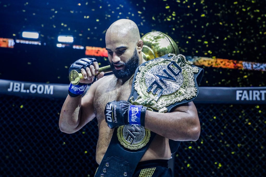 Arjan Bhullar celebrates with the ONE heavyweight world title. Photo: ONE Championship.