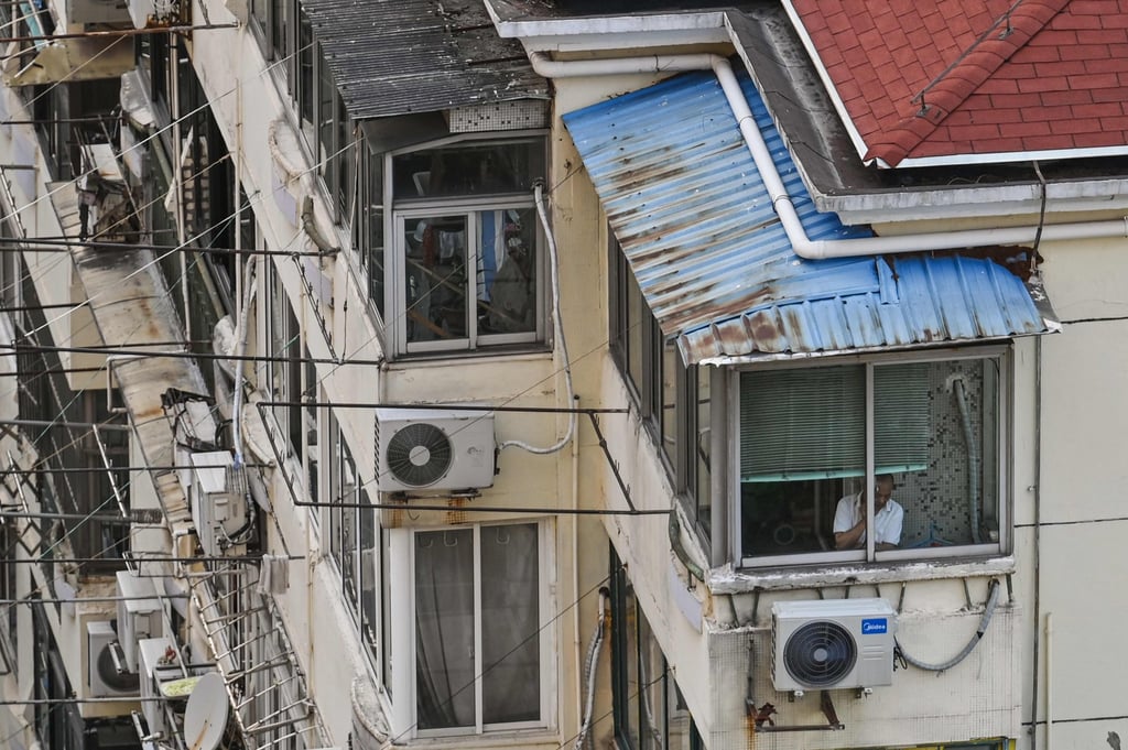 A man looks outside from his window during a Covid-19 lockdown in the Jing’an district in Shanghai on April 12, 2022. Photo: AFP