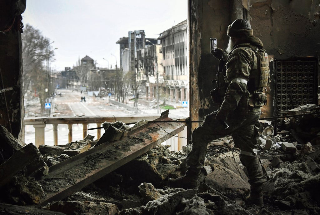 A Russian soldier patrols at the Mariupol drama theatre on Tuesday. Photo: AFP/Getty Images/TNS