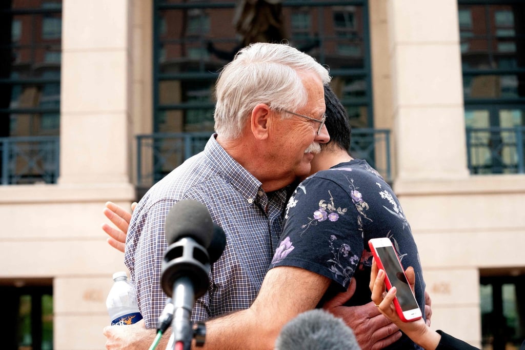 Carl Mueller, the father of Kayla Mueller, an American human rights activist slain by Islamic State militants, embraces Rodwan Safer Jalani, a friend of Kayla’s, outside the courthouse in Alexandria, Virginia on Thursday. Photo: AFP