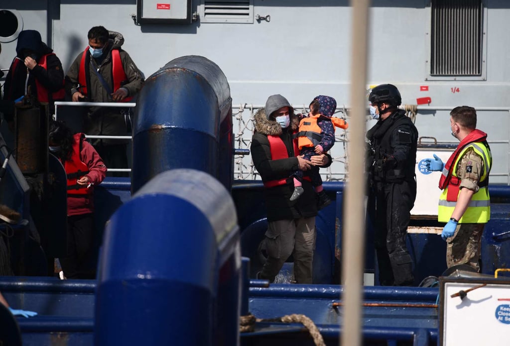 A group of migrants prepare to disembark from a UK Border Force boat in Dover, UK, having been picked up crossing the English Channel from France on Friday. Photo: AFP
