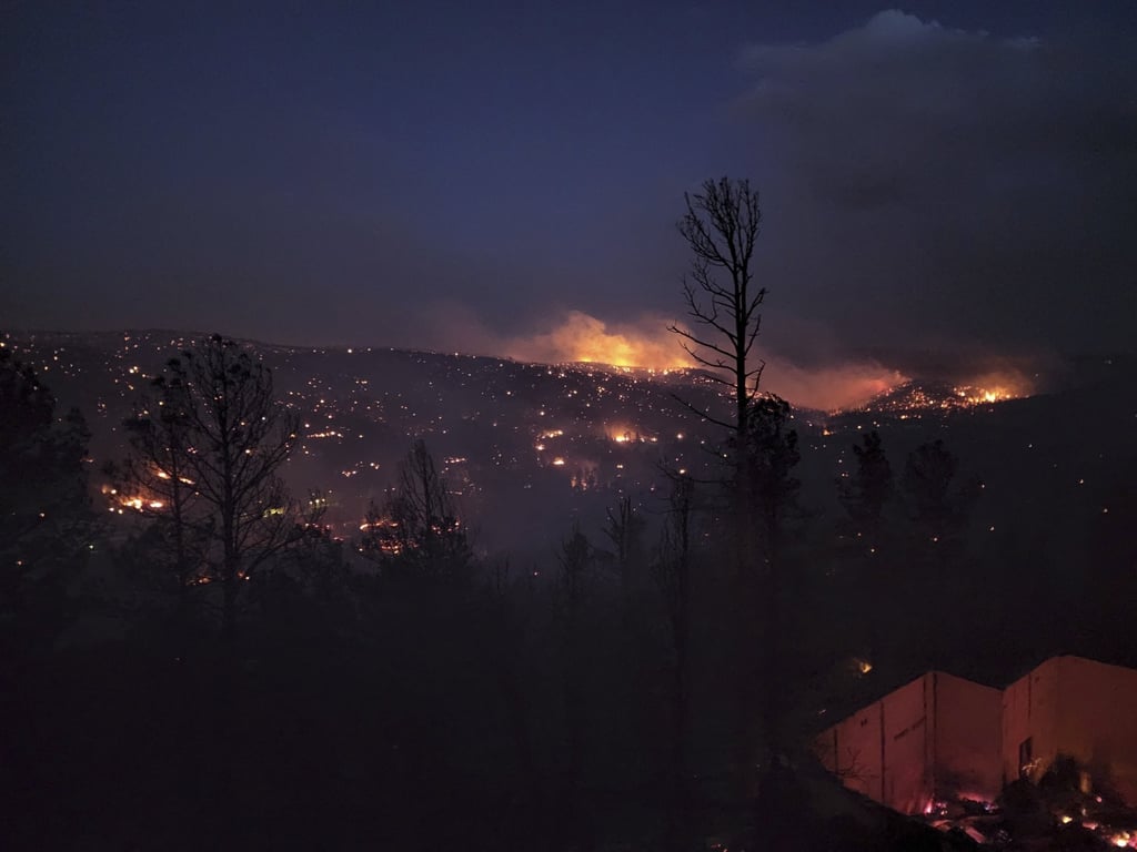 Fire burns along a hillside in Ruidoso, New Mexico. Photo: AP Fire burns along a hillside in Ruidoso, New Mexico. Photo: AP