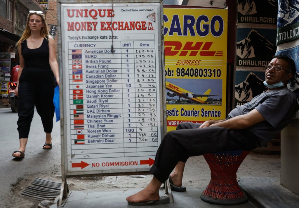 A man sits outside a money exchange site in Nepal. Photo: Reuters A man sits outside a money exchange site in Nepal. Photo: Reuters