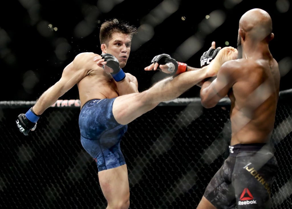 Henry Cejudo, left, kicks Demetrious Johnson during their UFC flyweight title mixed martial arts bout at UFC 227 in Los Angeles. Photo: AP