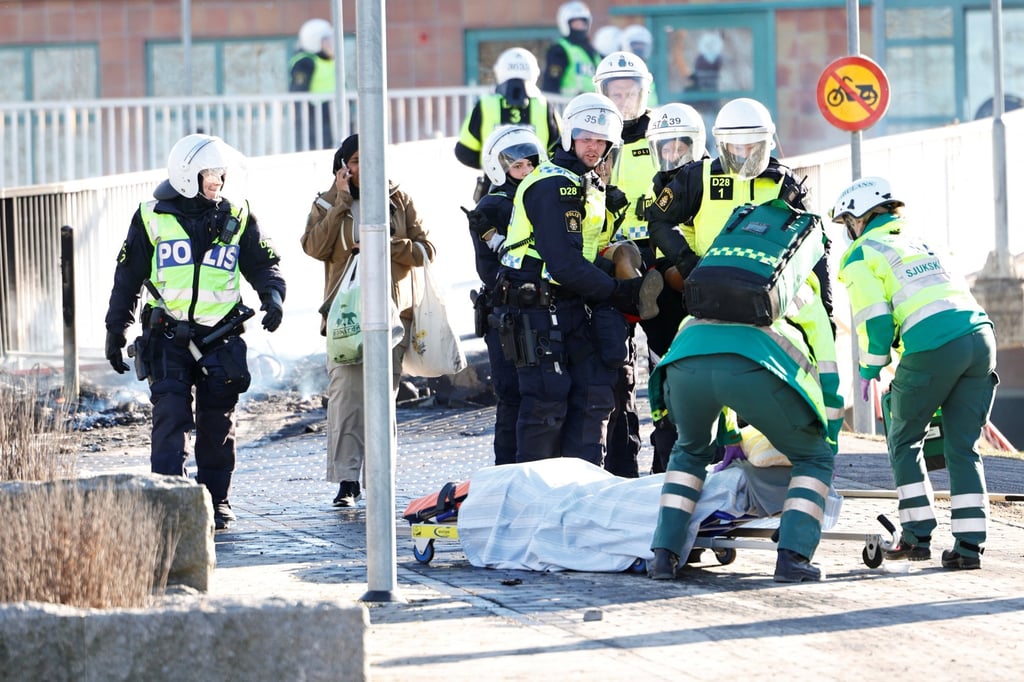 Police and ambulance staff carry an injured man who was shot in the leg during a riot in Norrkoping, Sweden on April 17. Photo: Stefan Jerrevang / TT News Agency via Reuters Police and ambulance staff carry an injured man who was shot in the leg during a riot in Norrkoping, Sweden on April 17. Photo: Stefan Jerrevang / TT News Agency via Reuters