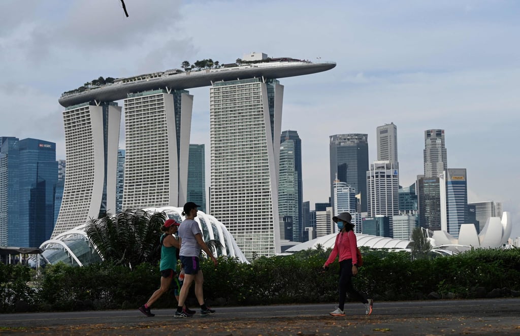 People walk along Marina Bay East Park in Singapore on October 20, 2021. Photo: AFP People walk along Marina Bay East Park in Singapore on October 20, 2021. Photo: AFP