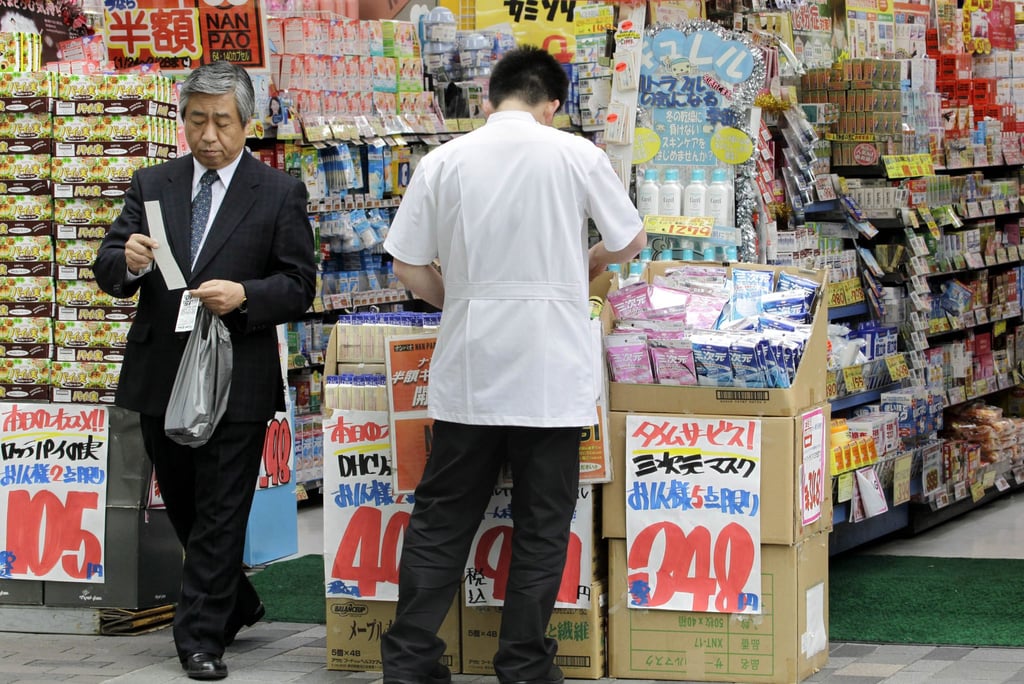 People shop at a discount store in Tokyo. File photo: AP