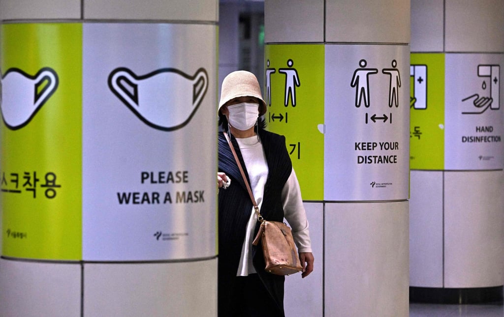A woman walks past posters showing precautions against the Covid-19 coronavirus at a subway station in Seoul on Friday. Photo: AFP A woman walks past posters showing precautions against the Covid-19 coronavirus at a subway station in Seoul on Friday. Photo: AFP