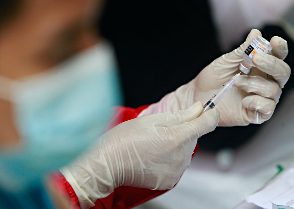 A healthcare worker prepares a dose of China’s Sinovac Biotech vaccine for Covid-19 on the outskirts of Jakarta, Indonesia. A study shows 99 per cent on Indonesia’s most populous island have Covid-antibodies. Photo: Reuters