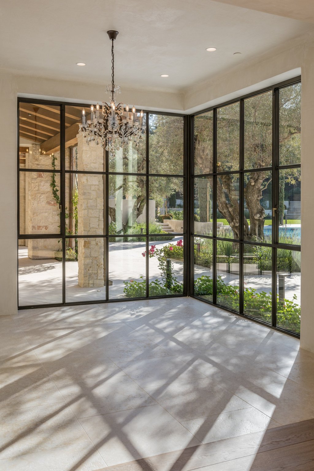 Classic touches like chandeliers often embellish otherwise modern interiors at the Woodside, Silicon Valley home. Photo: Paul Rollins