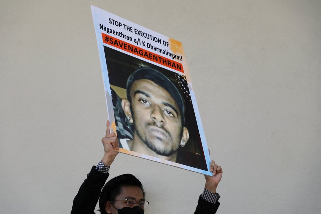 An activist holds a poster against the execution of Nagaenthran Dharmalingam, a Malaysian whose intellect, his defence and human rights groups have argued, was at a level recognised as a mental disability, for drug trafficking in Singapore. Photo: Reuters An activist holds a poster against the execution of Nagaenthran Dharmalingam, a Malaysian whose intellect, his defence and human rights groups have argued, was at a level recognised as a mental disability, for drug trafficking in Singapore. Photo: Reuters