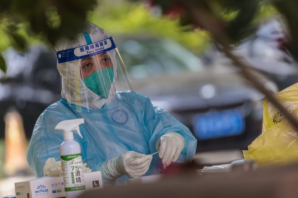 A medical worker prepares a Covid-19 test in Shanghai. Photo: EPA-EFE A medical worker prepares a Covid-19 test in Shanghai. Photo: EPA-EFE
