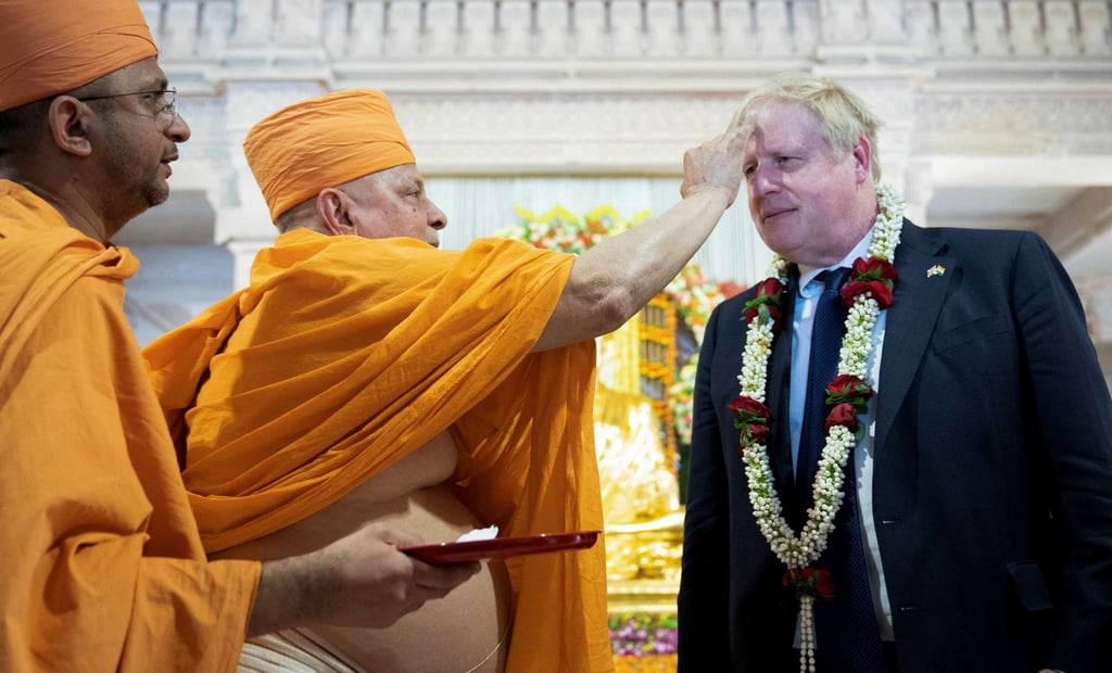 British Prime Minister Boris Johnson has tilak applied on his forehead by a senior sadhu as he visits the Swaminarayan Akshardham temple in Gandhinagar, India on Thursday. Photo: Reuters British Prime Minister Boris Johnson has tilak applied on his forehead by a senior sadhu as he visits the Swaminarayan Akshardham temple in Gandhinagar, India on Thursday. Photo: Reuters