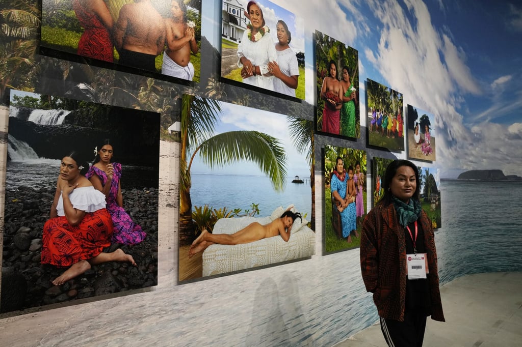 Third gender artist Yuki Kihara poses next to her installation ‘Paradise Camp’ during the Venice Biennale. Photo: AP
