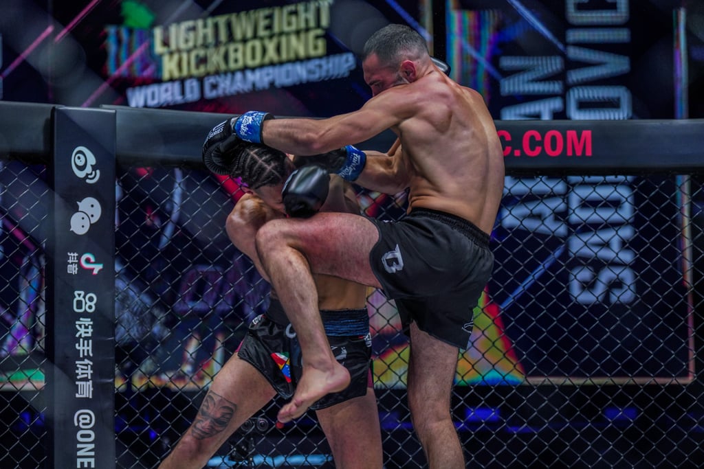 Arian Sadikovic (right) hits Regian Eersel with a knee in their lightweight kick-boxing title fight at ONE 156 in Singapore.