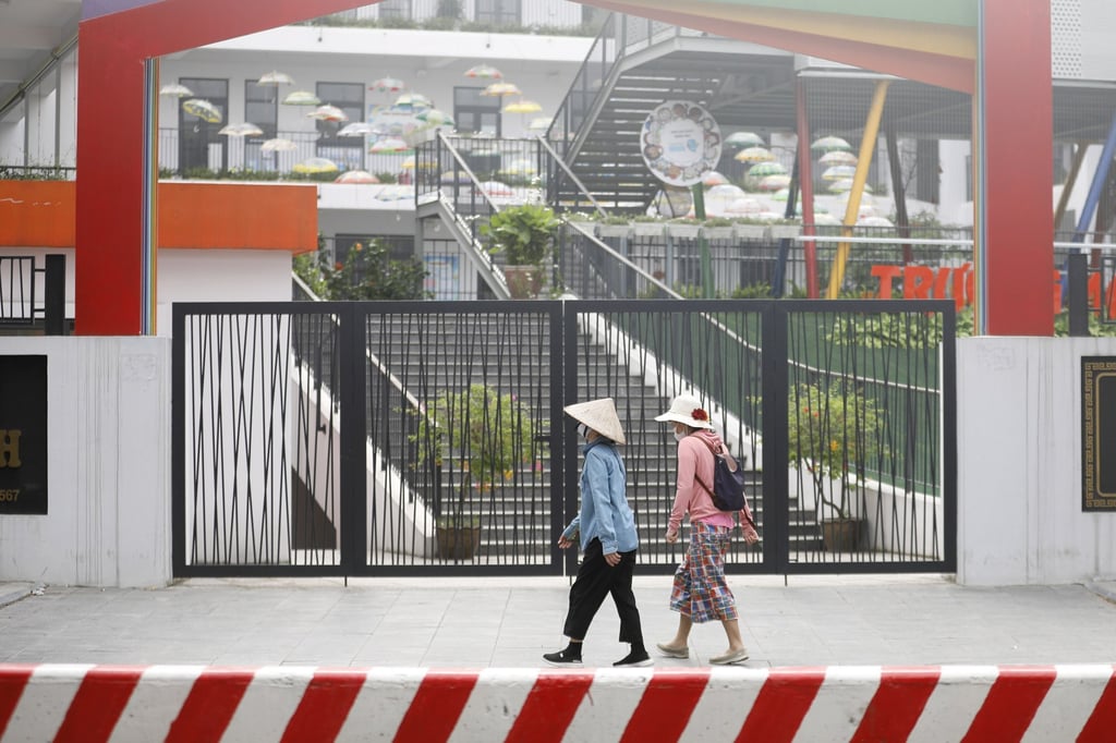 Two women walk past a closed school in Hanoi in May last year. Prolonged school closures have had negatively affected students’ mental health. Photo: EPA-EFE Two women walk past a closed school in Hanoi in May last year. Prolonged school closures have had negatively affected students’ mental health. Photo: EPA-EFE