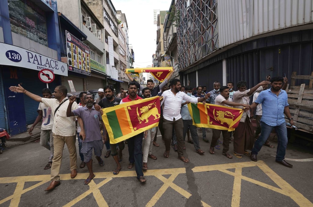 Sri Lankan traders march after closing their shops in protest to demand president Gotabaya Rajapaksa’s resignation. Photo: AP