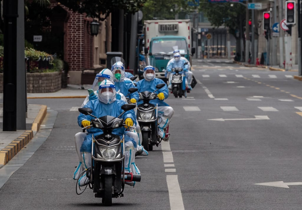 Medical personnel in protective gear rode scooters through Nanjing street in Shanghai on April 25, 2022. Photo: EPA-EFE Medical personnel in protective gear rode scooters through Nanjing street in Shanghai on April 25, 2022. Photo: EPA-EFE