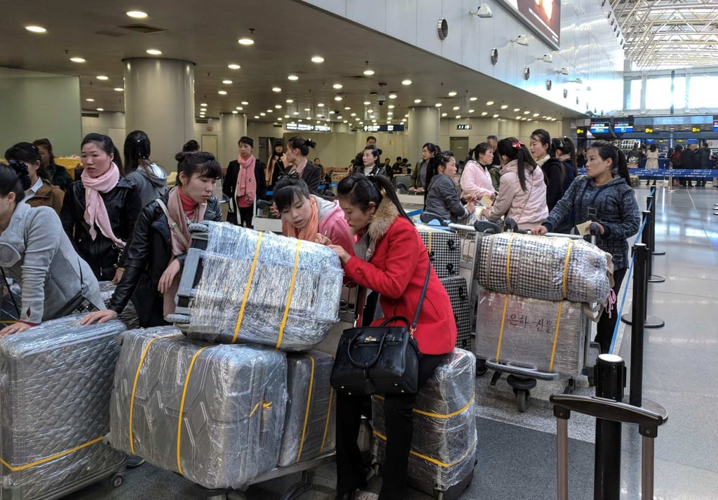 North Korean workers queue for a flight to Pyongyang at an airport in Beijing in 2019. Most of the knowledge needed to hack the phones came from North Koreans who had been sent to China for work, the report said. Photo: AFP