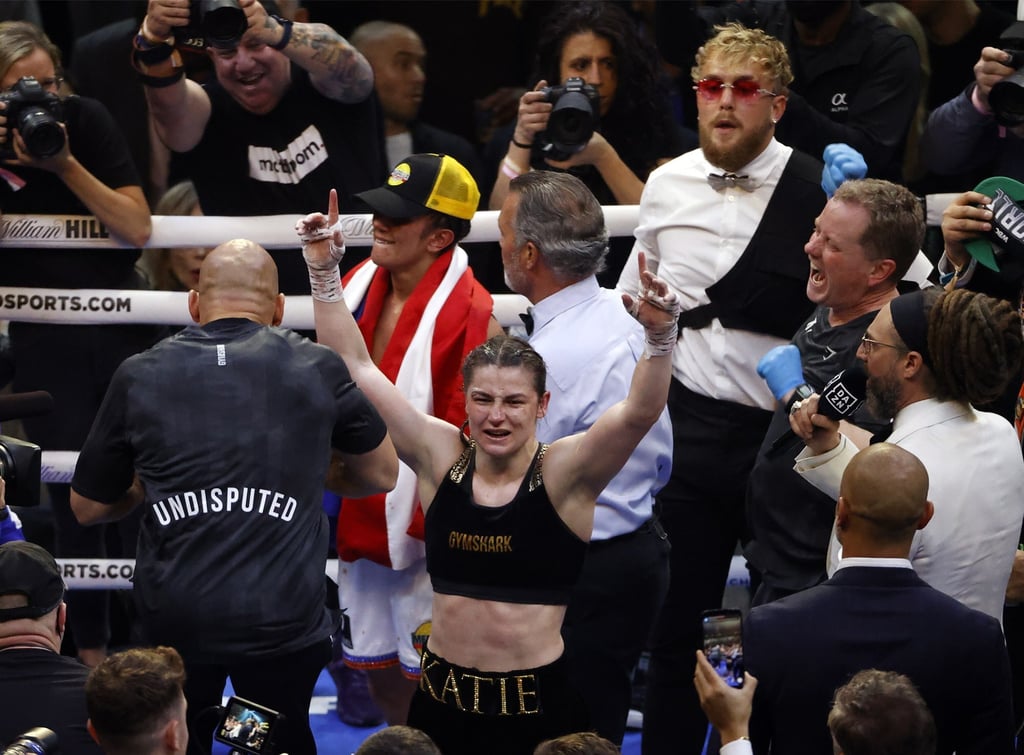 Jake Paul (back right) looks on as Katie Taylor (centre) celebrates her victory over Amanda Serrano. Photo: EPA-EFE