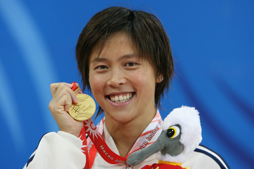Sherry Tsai Hiu-wai holds her gold medal after breaking an Asian Indoor Games record in the 200m individual medley in 2:13.95, on October 30, 2007. Photo: K.Y. Cheng