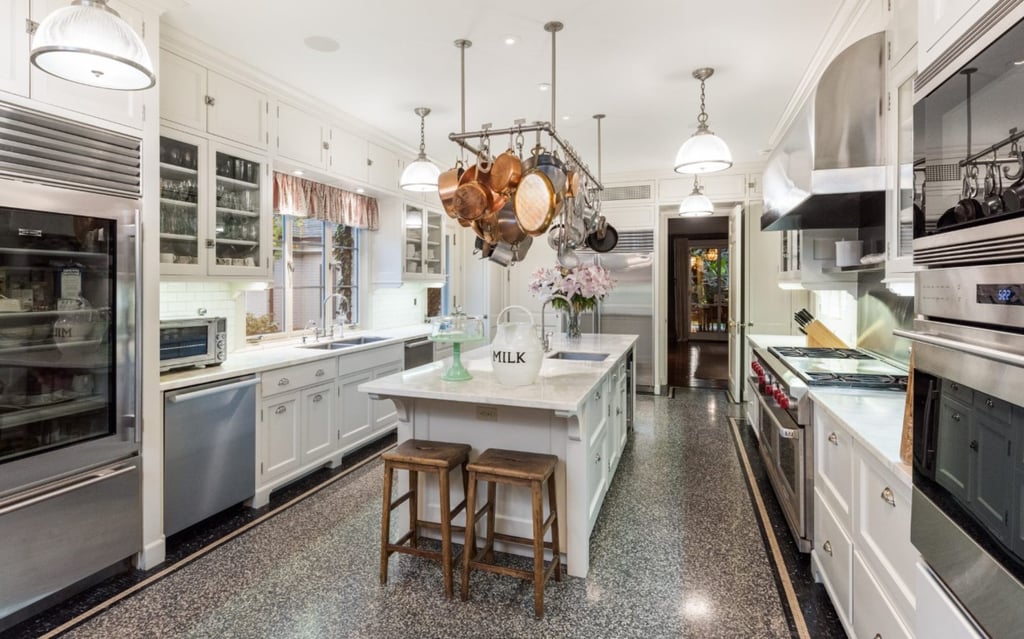 The versatile kitchen is a good place to prepare family meals, oversee homework or for caterers. Photo: Compass