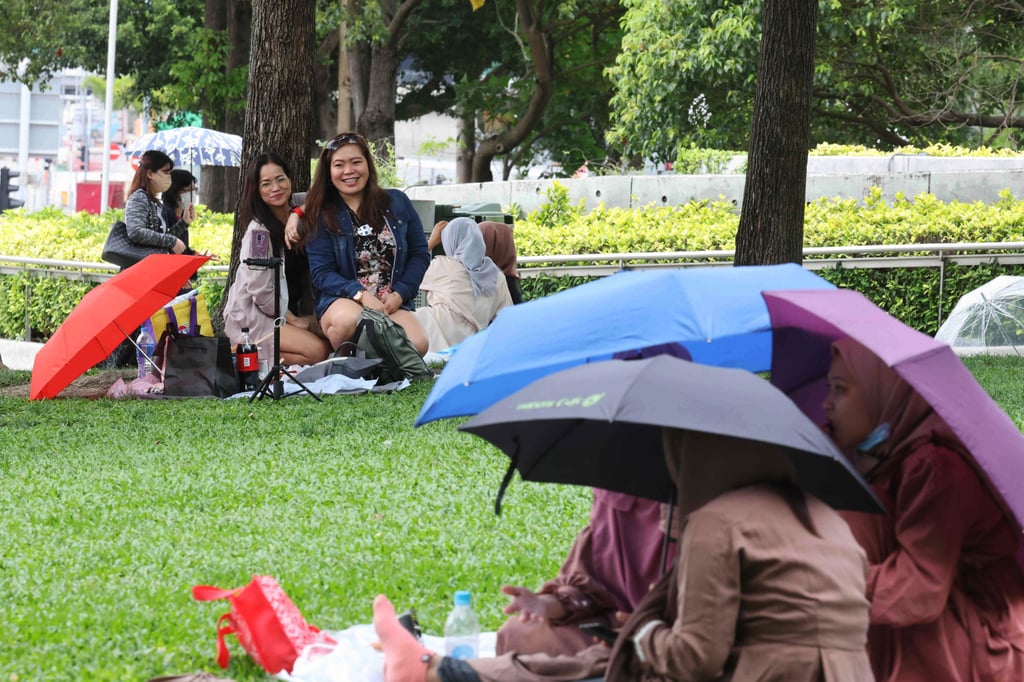 Indonesian maids in Tamar Park in May. Hong Kong launched an action plan to combat human trafficking and provide better protection for domestic helpers in 2018. Photo: Edmond So Indonesian maids in Tamar Park in May. Hong Kong launched an action plan to combat human trafficking and provide better protection for domestic helpers in 2018. Photo: Edmond So