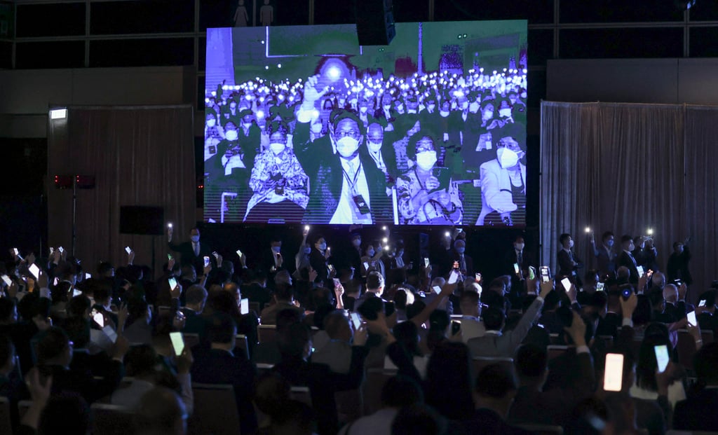 Rally attendees hold up their smartphones as John Lee prepared to take the stage at the Convention and Exhibition Centre. Photo: Felix Wong