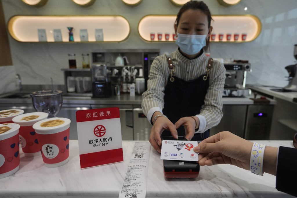 A coffee shop employee shows how to make a purchase using e-CNY at the National Fintech Demonstration Zone in Beijing on February 17, 2022. Photo: Simon Song