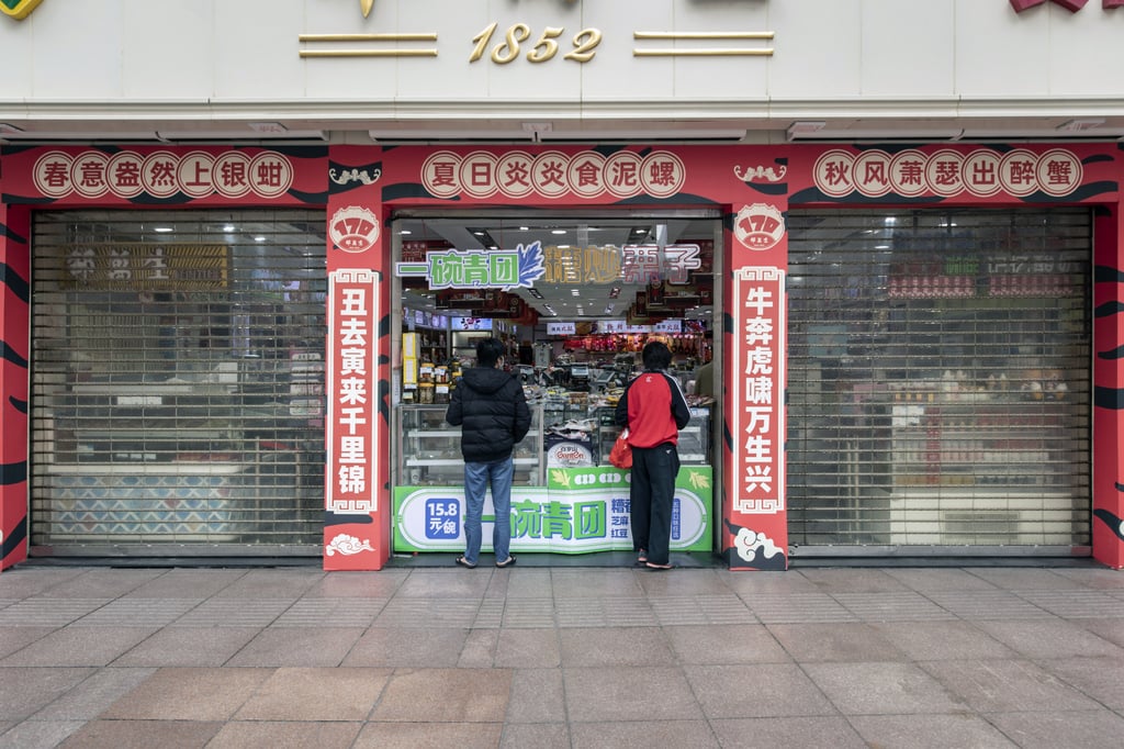 Shoppers seen along the near-empty Nanjing Road shopping belt in late March, just before the entire Shanghai city came under total lockdown. Photo: Bloomberg