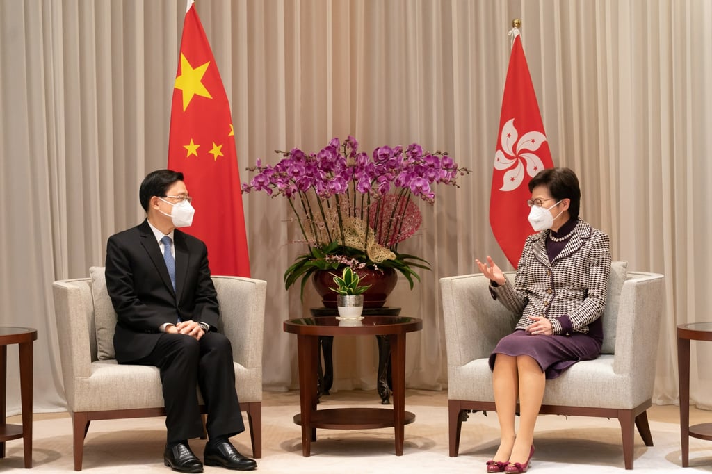 Lee and Lam discuss issues such as a proposed government restructuring and pandemic work. Photo: EPA-EFE