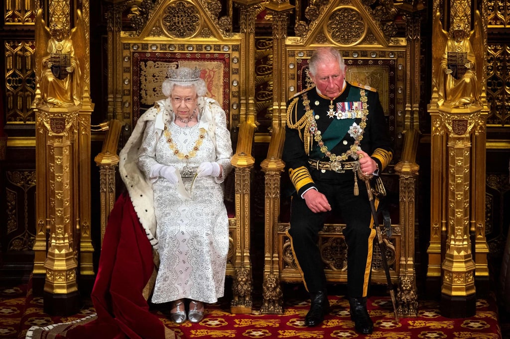 Britain’s Queen Elizabeth sits with Prince Charles on the Sovereign’s throne to deliver the Queen’s Speech at the state opening of parliament in London in October 2019. Photo: AFP