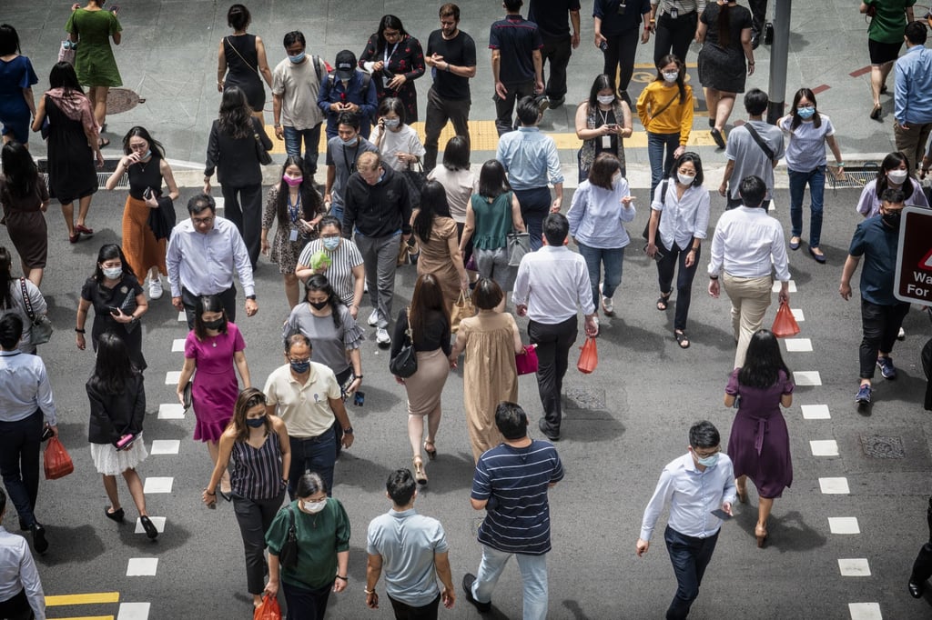 Pedestrians walk through Singapore’s central business district. The city state’s population is made up mainly of ethnic Chinese, Malays and Indians. Photo: Bloomberg Pedestrians walk through Singapore’s central business district. The city state’s population is made up mainly of ethnic Chinese, Malays and Indians. Photo: Bloomberg