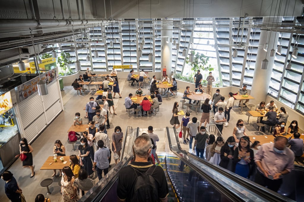Customers at the Market Street Hawker Centre during lunch hour in Singapore on April 26, 2022. The city has allowed workers to return to workplaces and done away with most vaccination-status checks. Photo: Bloomberg