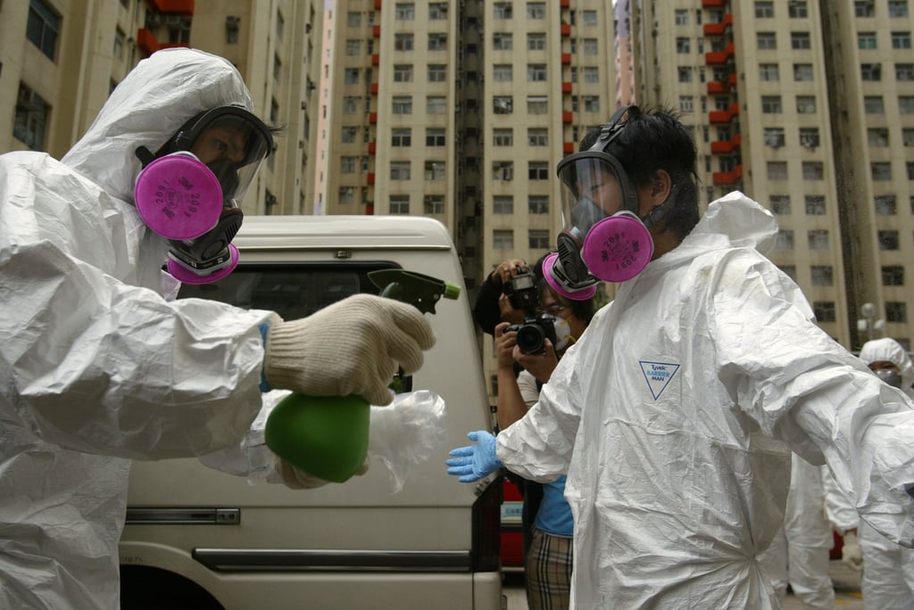 Government hygiene officials sterilise their overalls during the deadly Sars outbreak, which first reached Hong Kong in March 2003. Photo: Robert Ng