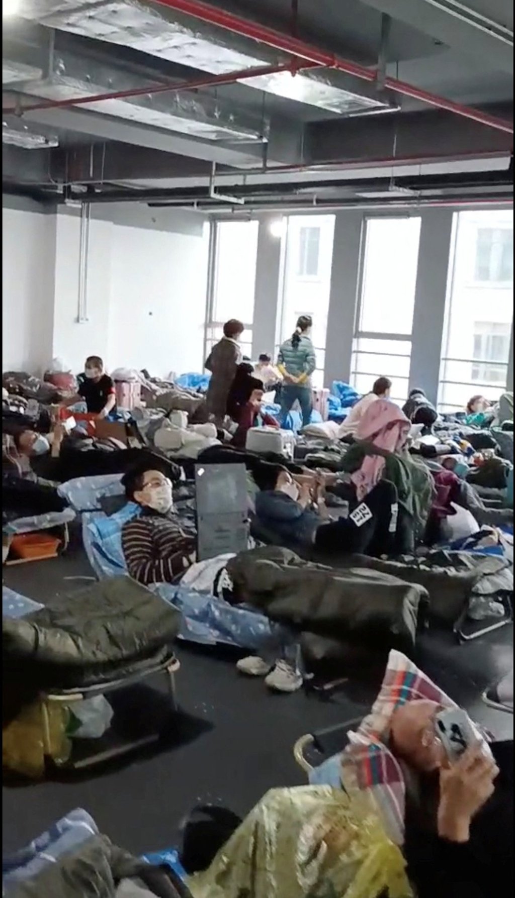 People rest at a quarantine centre near Linkong Skate Park in Shanghai’s Changning district in this still image from a social media video. Photo: Reuters People rest at a quarantine centre near Linkong Skate Park in Shanghai’s Changning district in this still image from a social media video. Photo: Reuters