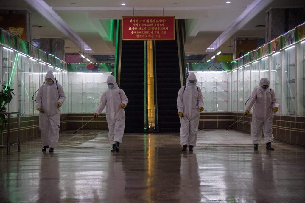 Workers spray disinfectant inside the Pyongyang Department Store No. 1 before opening for business. North Korea on Thursday confirmed its first-ever case of Covid-19, with state media declaring it a “severe national emergency incident” after more than two years of purportedly keeping the pandemic at bay. Photo: AFP