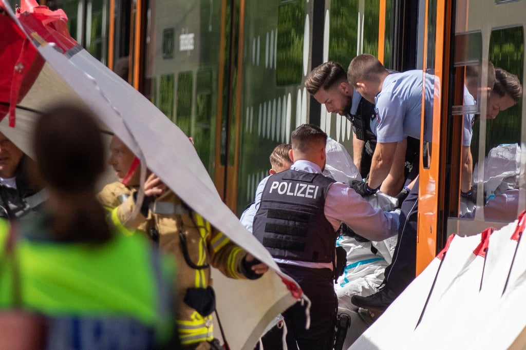 Police officers take the suspected perpetrator (3R) into custody after the man allegedly stabbed passengers with a knife on a regional train in Herzogenrath, near Aachen, Germany on Friday. Photo: EPA-EFE Police officers take the suspected perpetrator (3R) into custody after the man allegedly stabbed passengers with a knife on a regional train in Herzogenrath, near Aachen, Germany on Friday. Photo: EPA-EFE