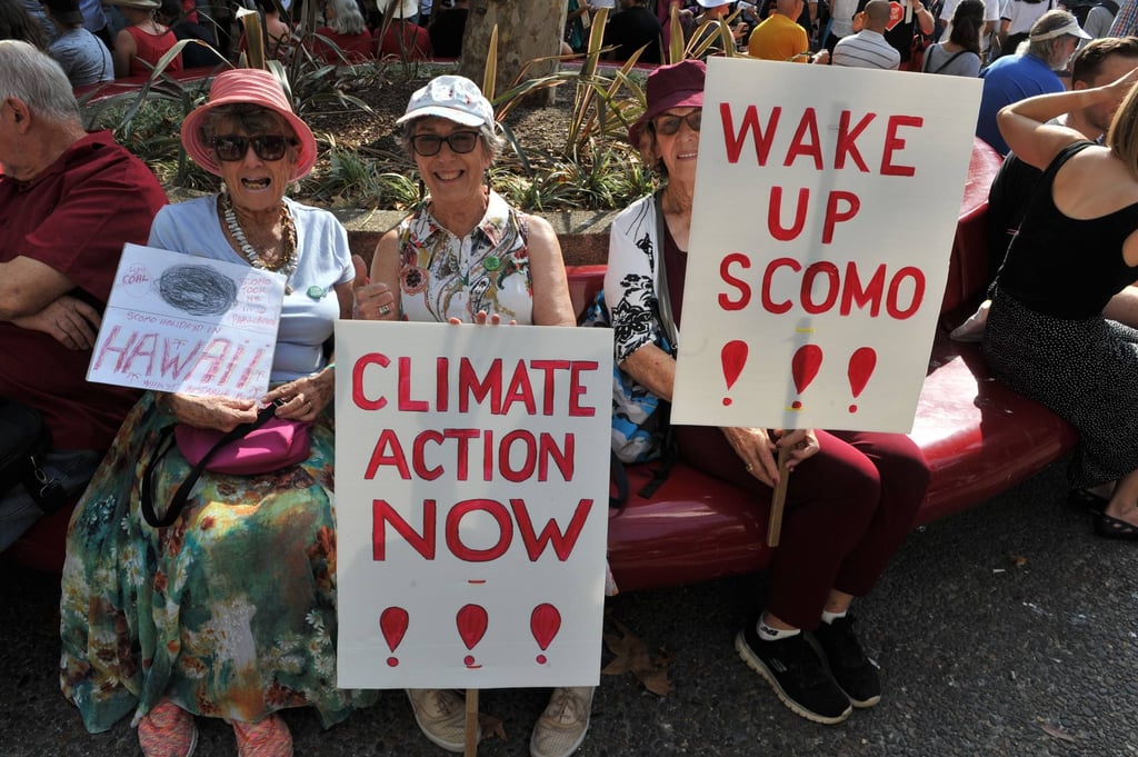 Participants hold placards as they take part in a demonstration demanding the government take immediate action against climate change in Sydney in January 2020, in the wake of deadly bush fires. Photo: AFP Participants hold placards as they take part in a demonstration demanding the government take immediate action against climate change in Sydney in January 2020, in the wake of deadly bush fires. Photo: AFP