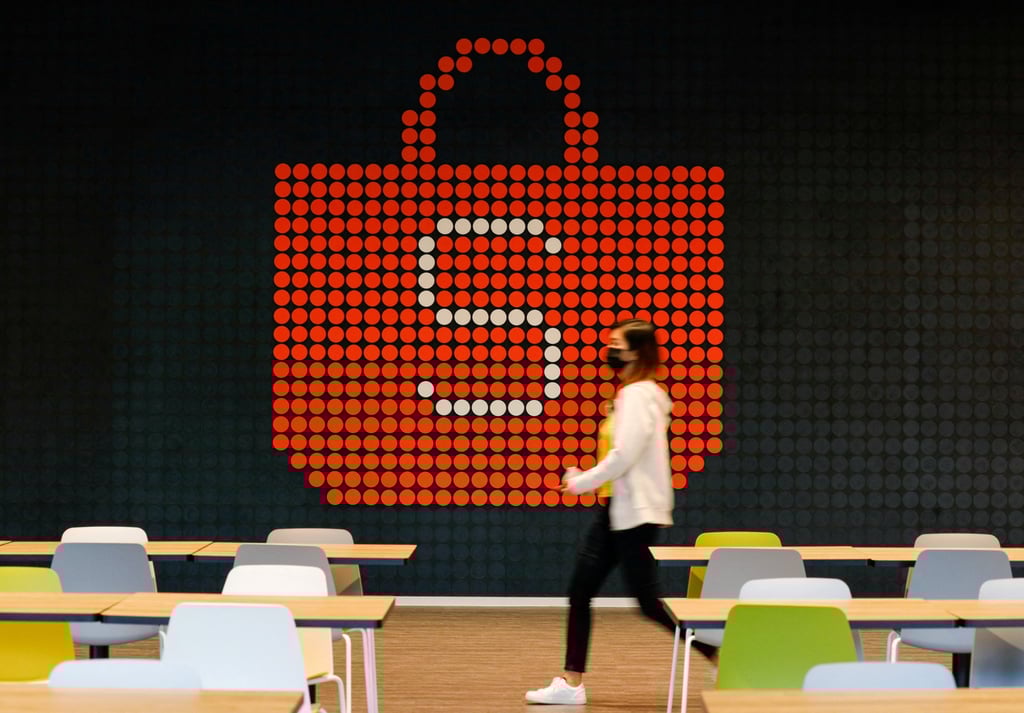 A person walks in front of a sign for Shopee, the e-commerce arm of Sea Ltd, at its office in Singapore. Photo: Reuters A person walks in front of a sign for Shopee, the e-commerce arm of Sea Ltd, at its office in Singapore. Photo: Reuters