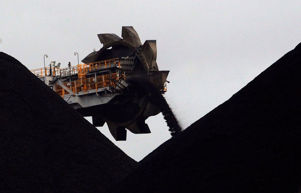 A machine stockpiles coal at a port in Newcastle, Australia. Gautam Adani’s conglomerate is expanding a controversial Australian coal mine. Photo: Reuters A machine stockpiles coal at a port in Newcastle, Australia. Gautam Adani’s conglomerate is expanding a controversial Australian coal mine. Photo: Reuters