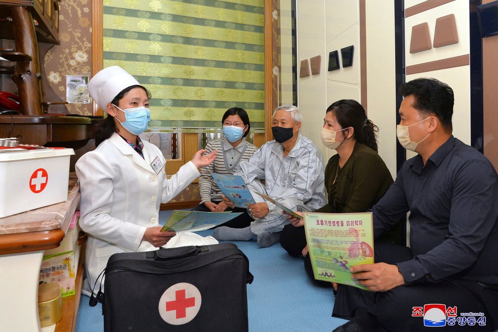 A medical worker talks to a family about Covid-19 prevention measures on Tuesday in this picture provided by the North Korean government. Photo: Korean Central News Agency/Korea News Service via AP