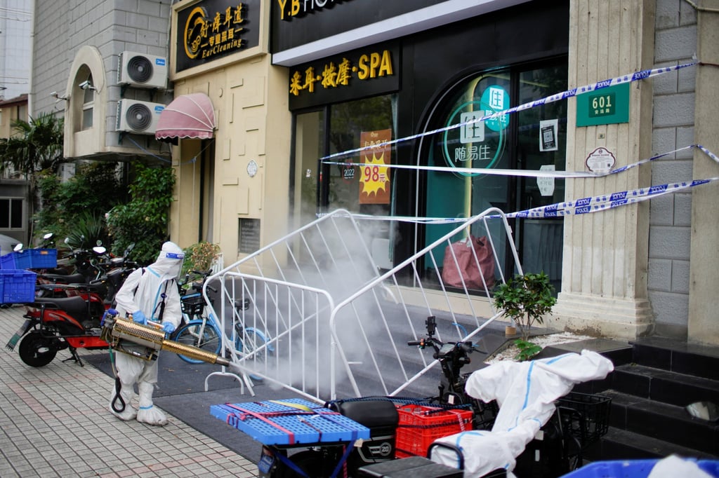 A worker in a protective suit disinfects a street on Friday amid Shanghai’s Covid-19 lockdown. Photo: Reuters