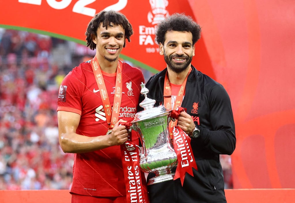 Liverpool’s Mohamed Salah and Trent Alexander-Arnold celebrate with the trophy after winning the FA Cup final. Photo: Reuters