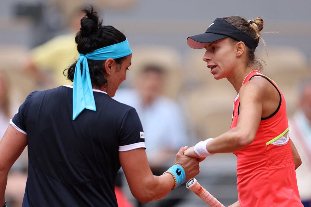Poland’s Magda Linette shakes hands with Tunisia’s Ons Jabeur after winning their first round match. Photo: Reuters