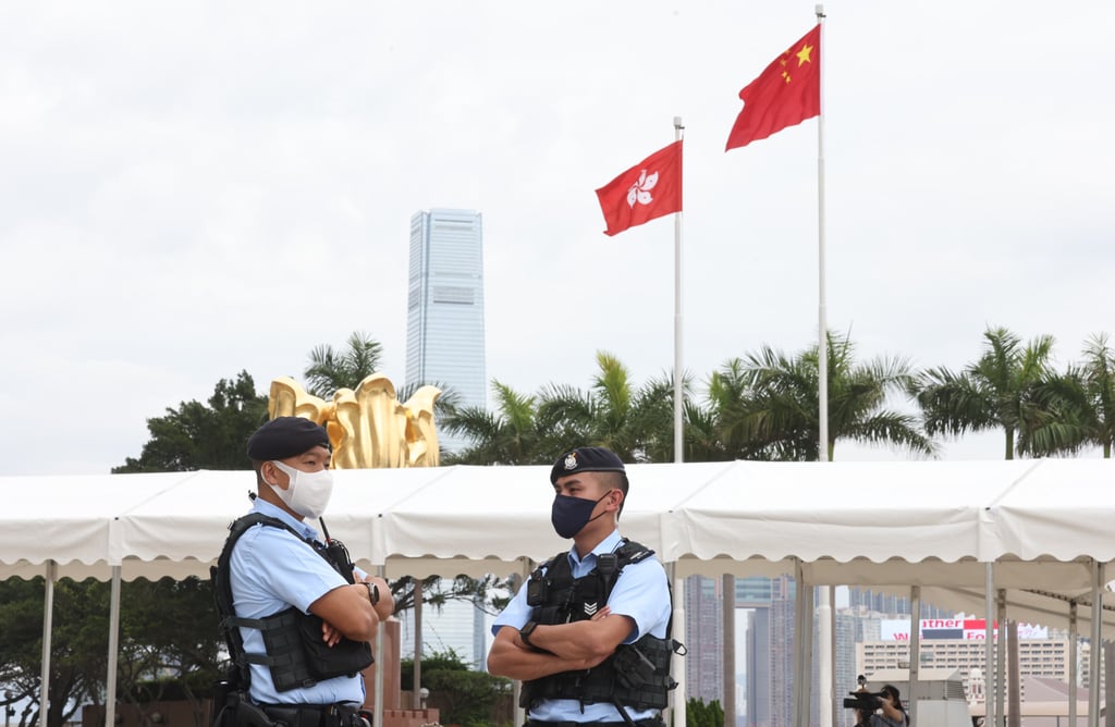 Police officers on duty outside the Convention and Exhibition Centre in Wan Chai, where voting in the chief executive election was held earlier this month. Photo: K. Y. Cheng