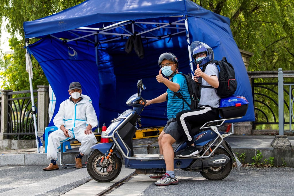 Residents on a scooter ride as people are allowed to leave their compound for a few hours during a relaxation of restrictions in the Pudong district of Shanghai on May 22, 2022. Photo: Agence France-Presse Residents on a scooter ride as people are allowed to leave their compound for a few hours during a relaxation of restrictions in the Pudong district of Shanghai on May 22, 2022. Photo: Agence France-Presse