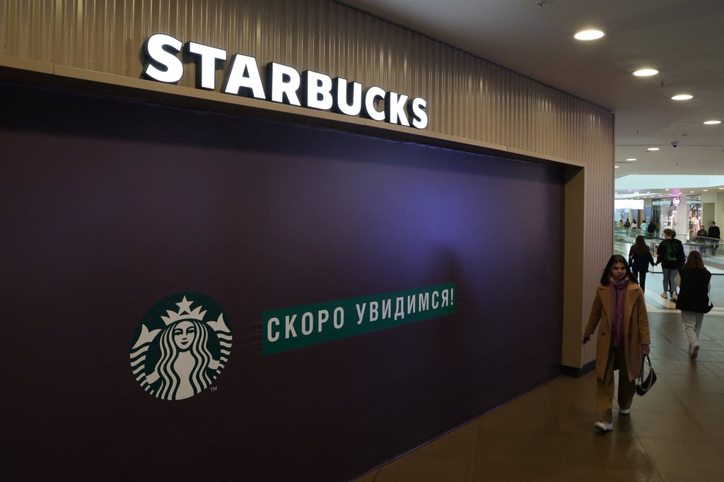 A woman walks past a closed Starbucks cafe in Saint Petersburg, Russia, on Monday. Photo: Reuters
