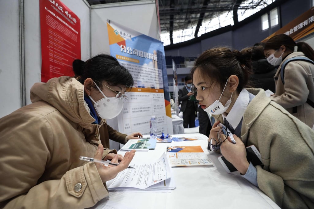 This photo taken March 10, 2021 shows a job seeker (right) being interviewed at a career fair in Wuhan, Hubei province. Photo: STR/AFP This photo taken March 10, 2021 shows a job seeker (right) being interviewed at a career fair in Wuhan, Hubei province. Photo: STR/AFP