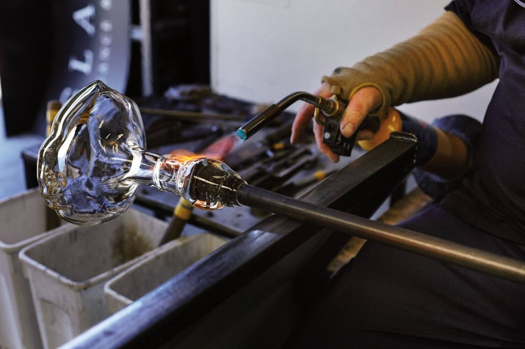 The Macallan collaborated with artisans to create unique packaging for The Reach, including a glass decanter with indentations that match the fingers of the sculpted bronze hands holding it. Photo: The Macallan